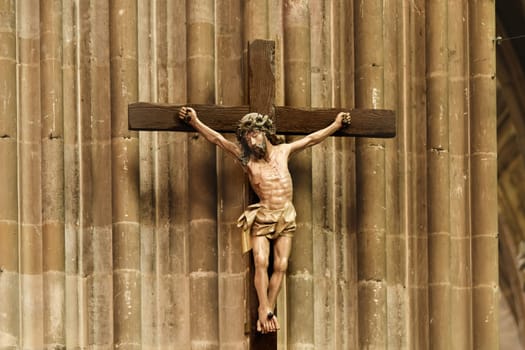 A statue of Jesus hanging on a cross in a church