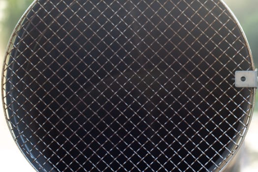 Metal pipe with a shallow grating close-up. Communications. Construction and repair. Landscaping. Metal structures.