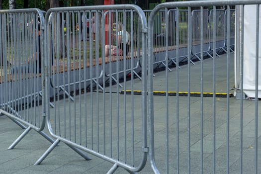 Metal fences at mass events protect people. Prohibition of passage.