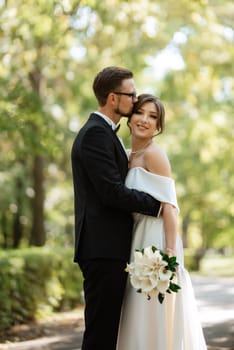 the first meeting of the bride and groom in wedding outfits in the park