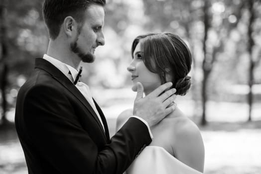 the first meeting of the bride and groom in wedding outfits in the park