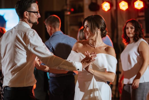 the first dance of the bride and groom inside a restaurant with heavy smoke