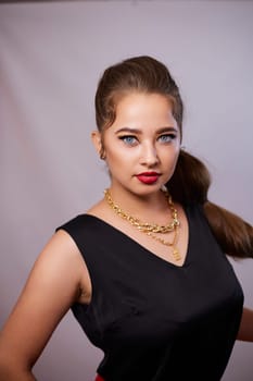 portrait shot of a young Ukrainian woman on the background, after make-up and hairstyle, for clothing advertising.