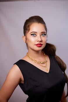 portrait shot of a young Ukrainian woman on the background, after make-up and hairstyle, for clothing advertising.