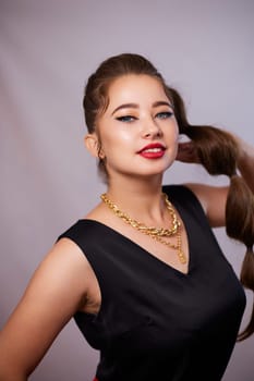 portrait shot of a young Ukrainian woman on the background, after make-up and hairstyle, for clothing advertising.