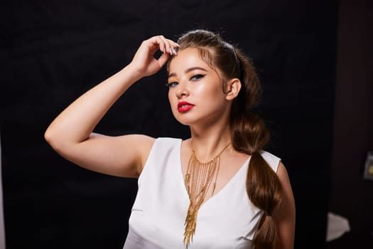 portrait shot of a young Ukrainian woman on the background, after make-up and hairstyle, for clothing advertising.