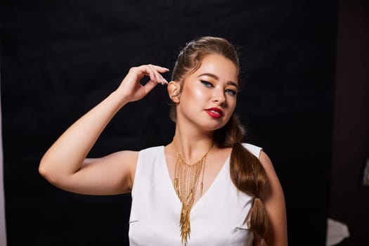 portrait shot of a young Ukrainian woman on the background, after make-up and hairstyle, for clothing advertising.