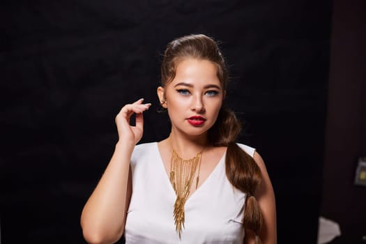 portrait shot of a young Ukrainian woman on the background, after make-up and hairstyle, for clothing advertising.