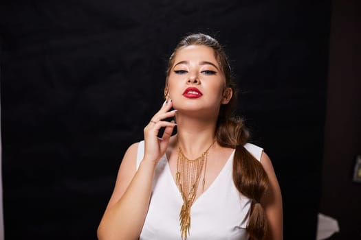 portrait shot of a young Ukrainian woman on the background, after make-up and hairstyle, for clothing advertising.