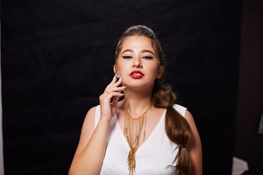 portrait shot of a young Ukrainian woman on the background, after make-up and hairstyle, for clothing advertising.