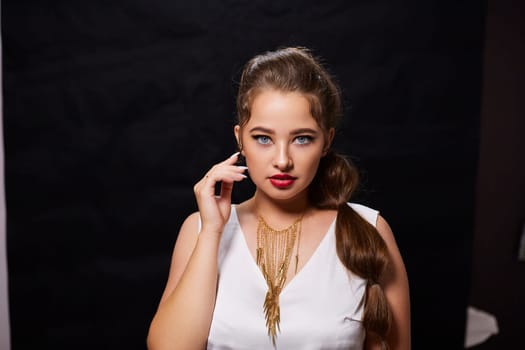 portrait shot of a young Ukrainian woman on the background, after make-up and hairstyle, for clothing advertising.