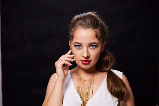 portrait shot of a young Ukrainian woman on the background, after make-up and hairstyle, for clothing advertising.