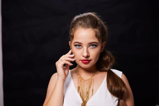 portrait shot of a young Ukrainian woman on the background, after make-up and hairstyle, for clothing advertising.