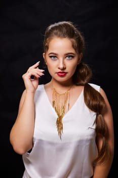 portrait shot of a young Ukrainian woman on the background, after make-up and hairstyle, for clothing advertising.