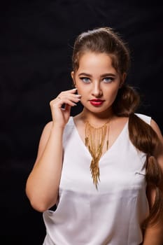 portrait shot of a young Ukrainian woman on the background, after make-up and hairstyle, for clothing advertising.