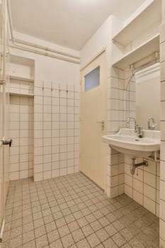 a bathroom with tile flooring and white tiles on the walls there is a sink, mirror and shower stall