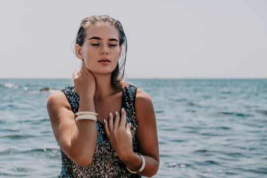 Woman travel sea. Young Happy woman in a long red dress posing on a beach near the sea on background of volcanic rocks, like in Iceland, sharing travel adventure journey