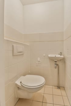 a bathroom with white tiles and a toilet in the corner, it appears to be used as a shower stall