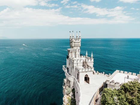 Aerial view of Swallow's Nest castle on the rock in Black Sea. It is a symbol and landmark of Crimea. Beautiful scenic panorama of the Crimea coast. Amazing Swallow's Nest at the precipice.