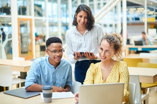 Good communication keeps projects constructive and productive. a group of young businesspeople using a laptop in a modern office