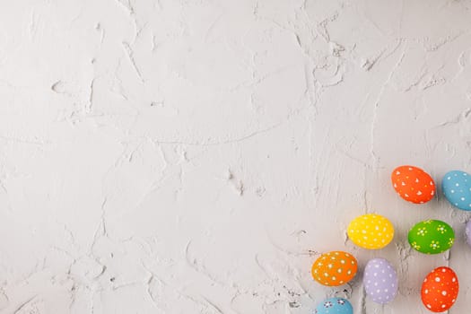 Happy Easter Day Concept. Top view holiday banner background web design white colorful easter eggs painted on cement background with empty copy space, celebration greeting card, overhead, template