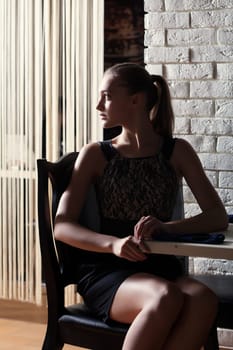 Young attractive woman posing in cafe, close-up