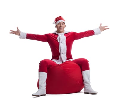 Full length portrait of young Santa sitting on bag. Isolated on white