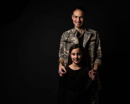 military man and daughter on a black background