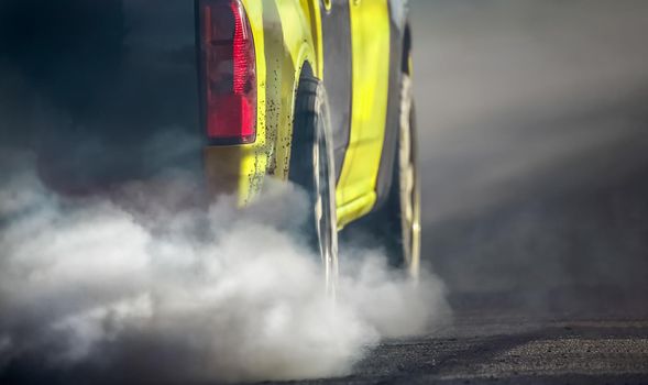 Air pollution from vehicle exhaust pipe on road