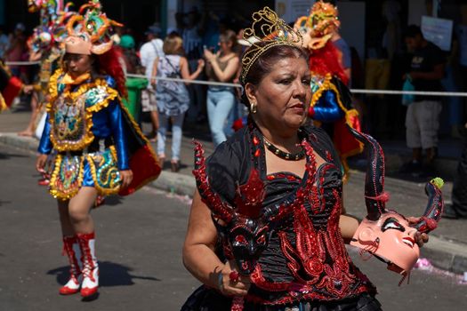 ARICA, CHILE - JANUARY 23, 2016: Young women performing the Diablada (dance of the devil) as part of the Carnaval Andino con la Fuerza del Sol in Arica, Chile. The dance originates in Oruro, Bolivia