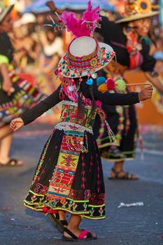 Arica, Chile - January 23, 2016: Tinkus dancing group in colourful costumes performing a traditional ritual dance as part of the Carnaval Andino con la Fuerza del Sol in Arica, Chile.