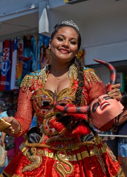 ARICA, CHILE - JANUARY 23, 2016: Young women performing the Diablada (dance of the devil) as part of the Carnaval Andino con la Fuerza del Sol in Arica, Chile. The dance originates in Oruro, Bolivia