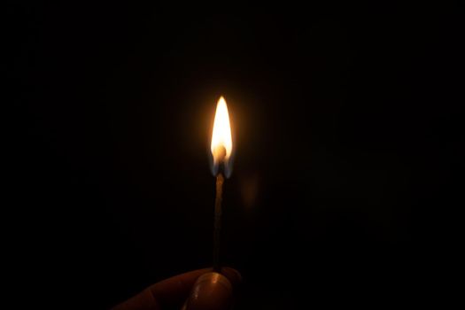 Burning match in the dark close up, macro photo