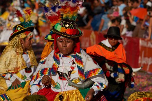 Arica, Chile - January 23, 2016: Members of a Waca Waca dance group in ornate costume performing at the annual Carnaval Andino con la Fuerza del Sol in Arica, Chile.