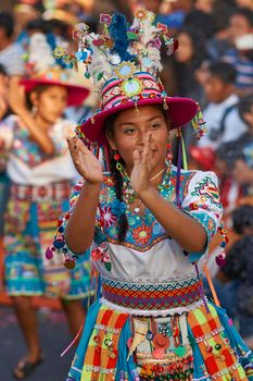 Arica, Chile - January 23, 2016: Tinkus dancing group in colourful costumes performing a traditional ritual dance as part of the Carnaval Andino con la Fuerza del Sol in Arica, Chile.