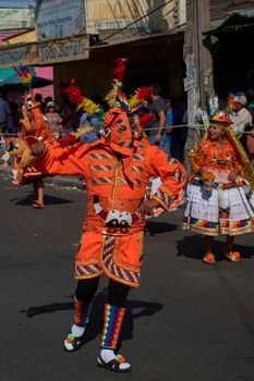 Arica, Chile - January 23, 2016: Members of a Waca Waca dance group in ornate costume performing at the annual Carnaval Andino con la Fuerza del Sol in Arica, Chile.