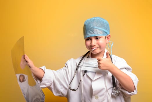 Cute child in doctor coat with stethoscope on color background. Space for text