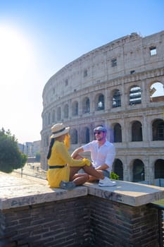 Young couple mid age on a city trip in Rome Italy Europe, Colosseum Coliseum building in Rome, Italy at summer