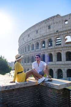 Young couple mid age on a city trip in Rome Italy Europe, Colosseum building in Rome, Italy at summer