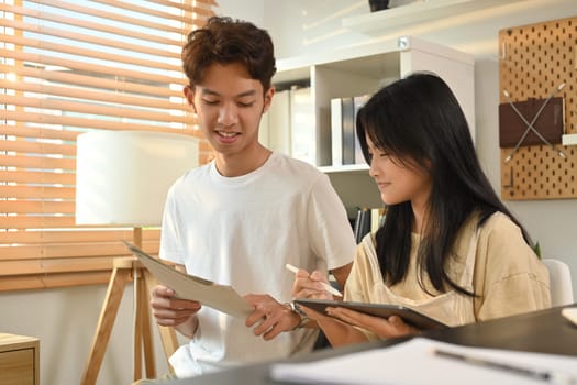 Teenage student woman doing homework and lesson practice preparing exam with tutor. Education and homeschooling concept.