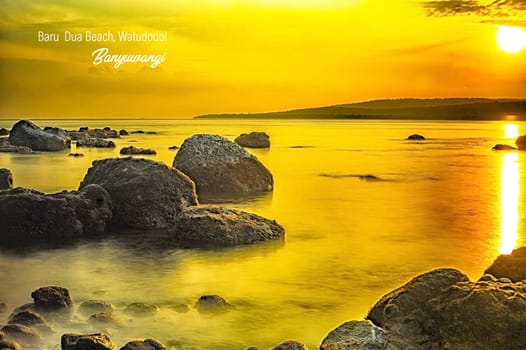 Rocks on the beach during sunrise in Banyuwangi, Indonesia. Long exposure photography. Defocused.