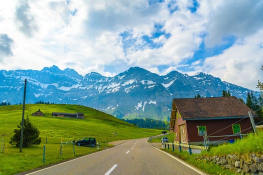 Road with snowy alps mountains, Schoenengrund, Hinterland, Appenzell Ausserrhoden Switzerland.