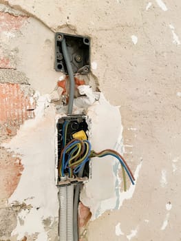 Broken electrical sockets in the wall, close-up, Indoor electrical wiring repair, fixing system. High quality photo. High quality photo