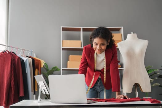 Female stylist Successful Fashion Business. Portrait of Smiling Black Designer stylish standing and working at fashion studio. Portrait of fashion designer in office..