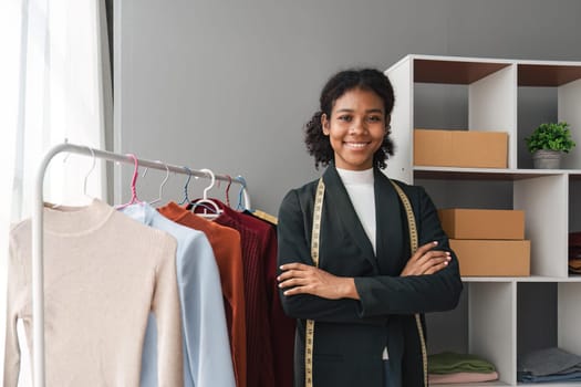 Female stylist Successful Fashion Business. Portrait of Smiling Black Designer stylish standing and working at fashion studio. Portrait of fashion designer in office..