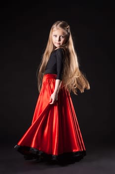 Full length portrait of little girl in oriental hispanic costume dance flamenco