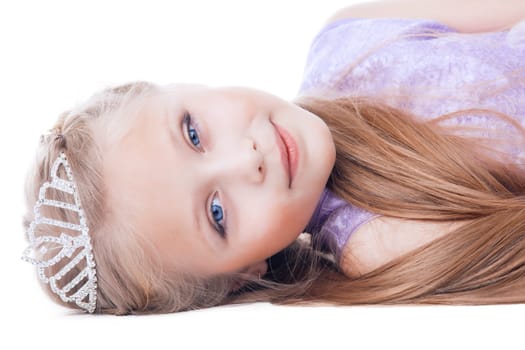 Portrait of beautiful little girl lay in tiara on head. Isolated on white