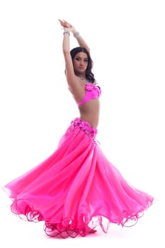 Full length portrait of beautiful woman dancer in pink arabian costume. Isolated on white