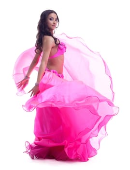Full length portrait of dancer in pink costume performing oriental dance. Isolated on white