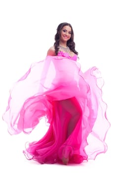 Full length portrait of dancer in pink costume performing oriental dance. Isolated on white